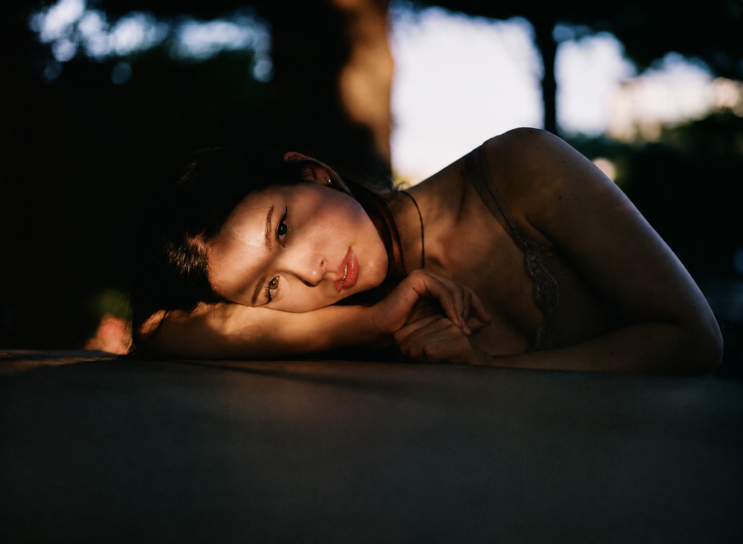 Woman resting her head on her arm outdoors